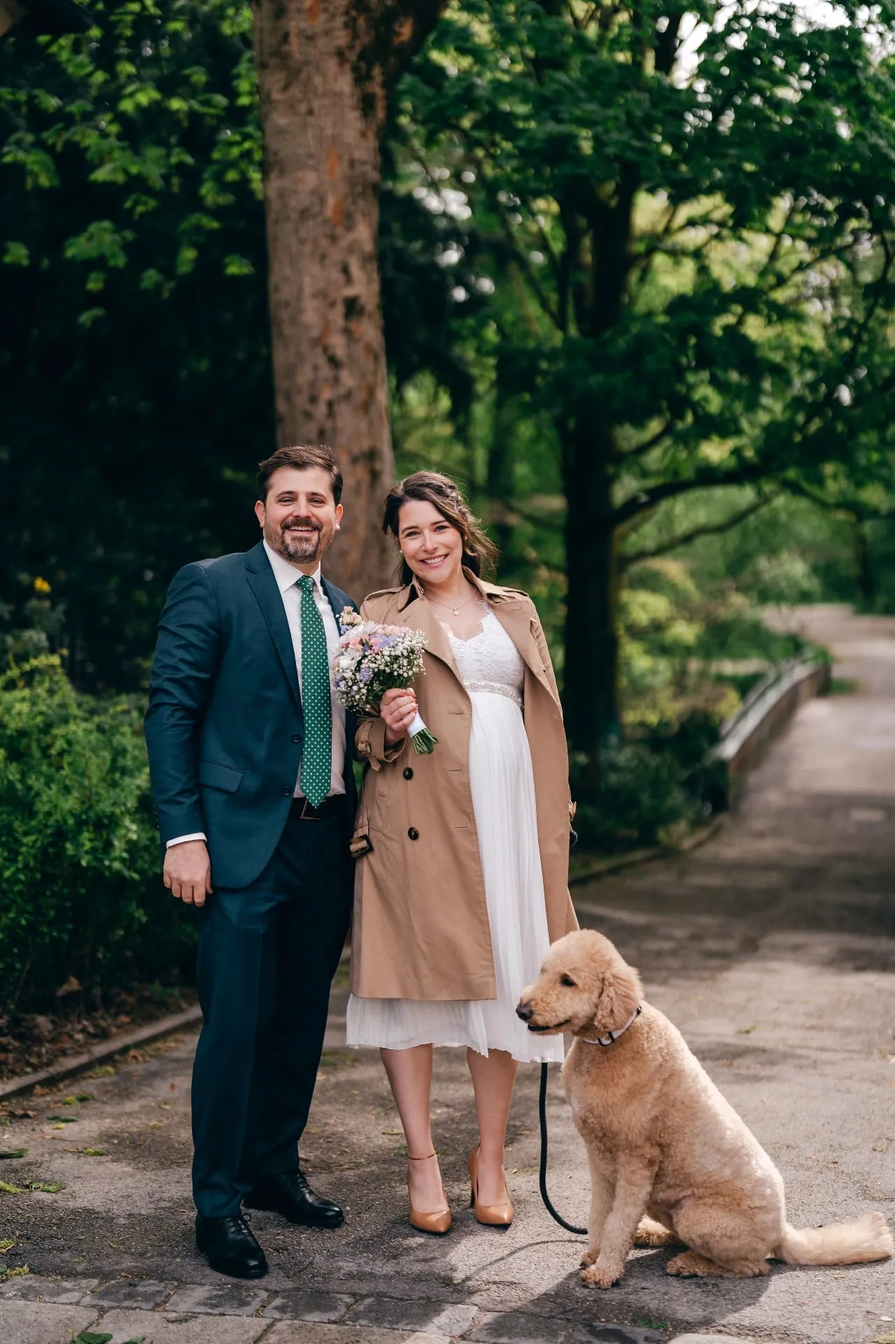 Brautpaar mit Hund in einem Münchner Park, kreative Hochzeitsfotografie Schwabing
